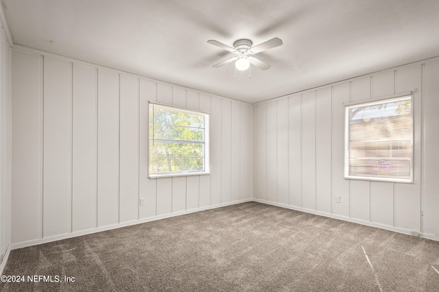 spare room featuring carpet floors and a ceiling fan