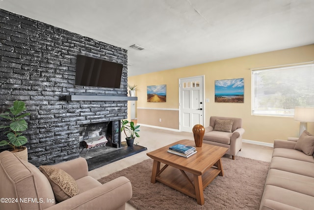 living room with light carpet, a brick fireplace, baseboards, and visible vents