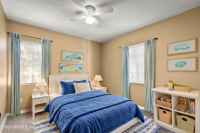 bedroom with carpet floors, multiple windows, baseboards, and a ceiling fan