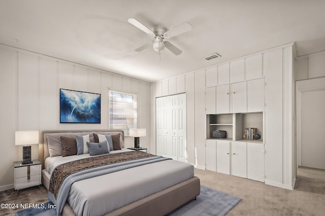 bedroom with carpet floors, visible vents, and a ceiling fan