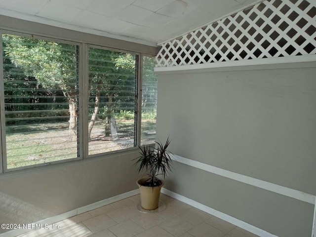 unfurnished sunroom featuring bar and a wealth of natural light