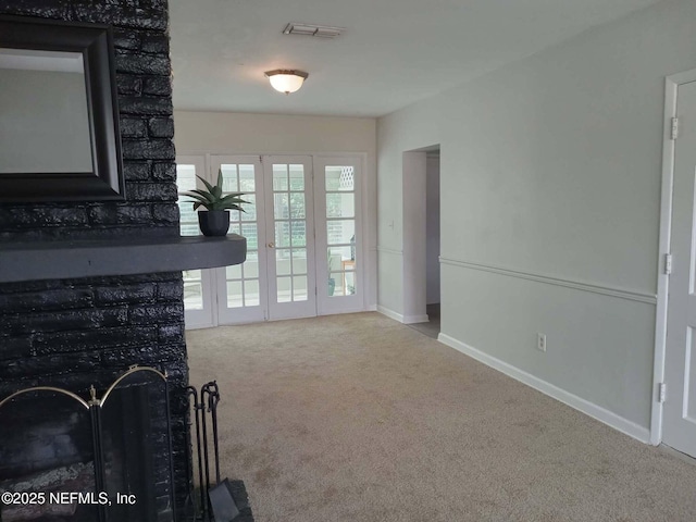 carpeted living room featuring baseboards and visible vents