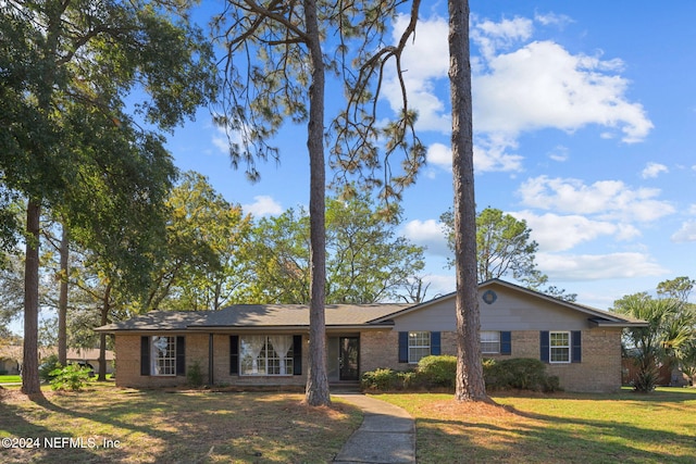 ranch-style house with a front lawn