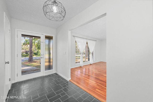 interior space with a textured ceiling and dark hardwood / wood-style floors