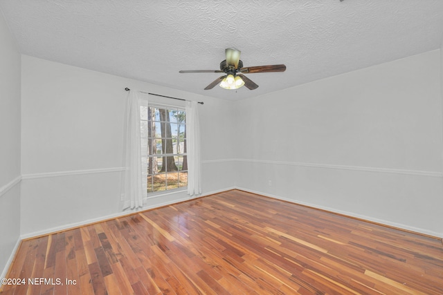 unfurnished room with hardwood / wood-style flooring, ceiling fan, and a textured ceiling