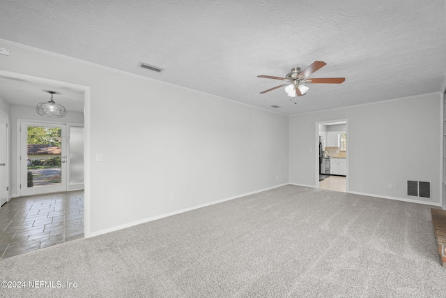 empty room featuring a textured ceiling, carpet floors, and ceiling fan