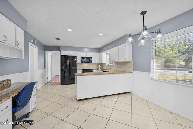 kitchen featuring decorative backsplash, a textured ceiling, black appliances, decorative light fixtures, and white cabinetry