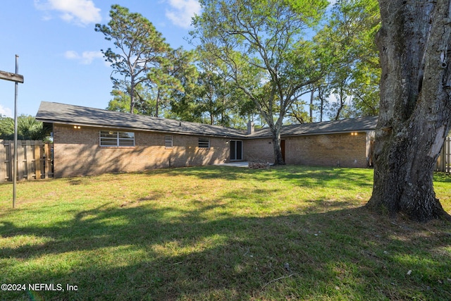 rear view of house with a lawn