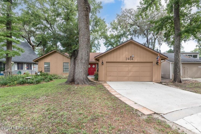 single story home featuring a front yard and a garage