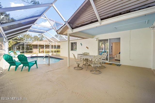 view of pool with a patio and a lanai