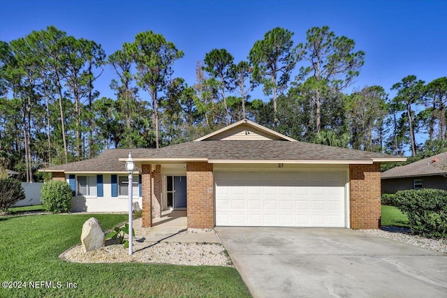 single story home featuring a garage and a front lawn