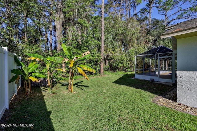 view of yard with glass enclosure