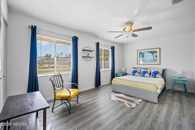 bedroom with wood-type flooring, a textured ceiling, a closet, and ceiling fan