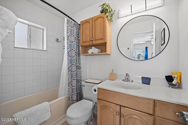 full bathroom with ceiling fan, a textured ceiling, toilet, vanity, and shower / tub combo