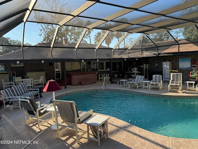 view of swimming pool with a lanai, a patio, and a hot tub