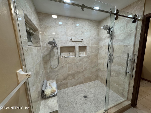 bathroom with tile patterned flooring and a shower with door