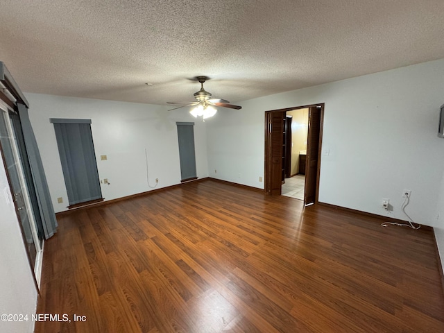 spare room featuring a textured ceiling, dark hardwood / wood-style floors, and ceiling fan