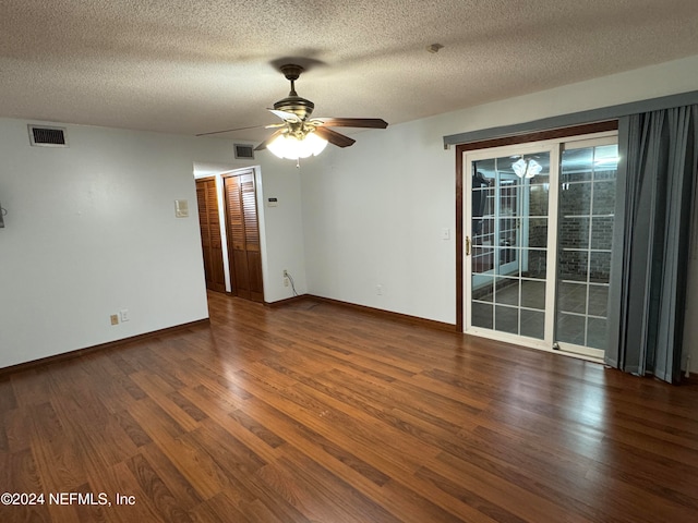 spare room featuring ceiling fan, dark hardwood / wood-style flooring, and a textured ceiling