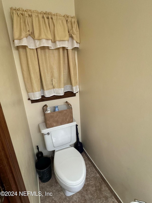 bathroom with tile patterned flooring and toilet