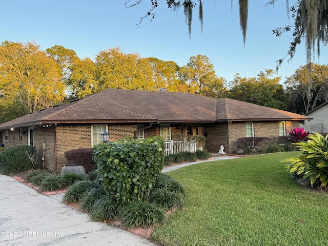 single story home featuring a front yard