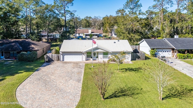 view of front of property with a front yard and a garage