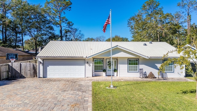 single story home featuring a front lawn and a garage