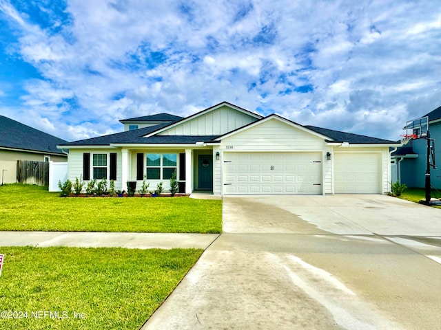 view of front of house with a front yard and a garage