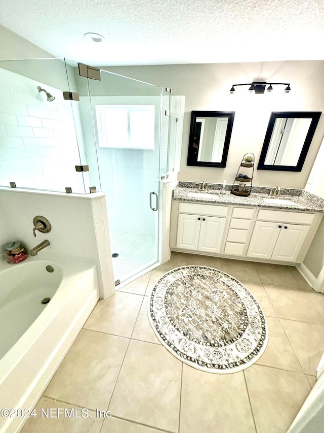 bathroom featuring vanity, tile patterned floors, a textured ceiling, and separate shower and tub