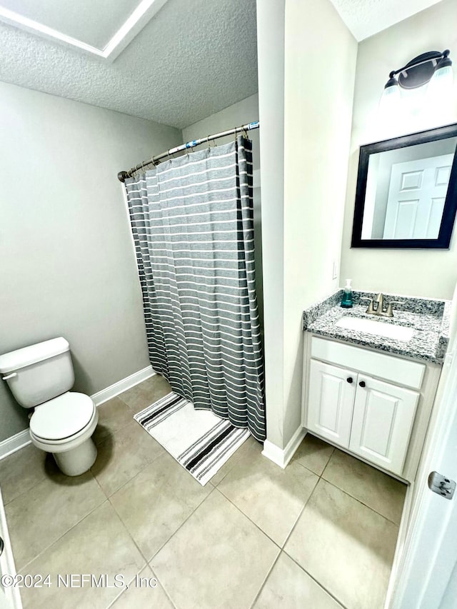 bathroom featuring walk in shower, tile patterned floors, a textured ceiling, toilet, and vanity