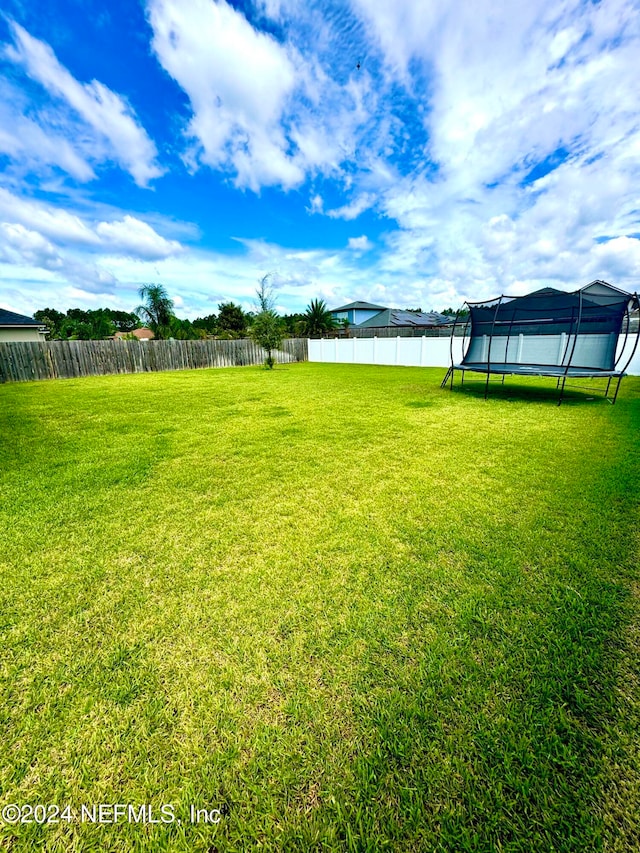 view of yard with a trampoline