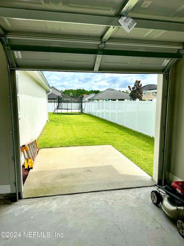 exterior space with a trampoline and a lawn