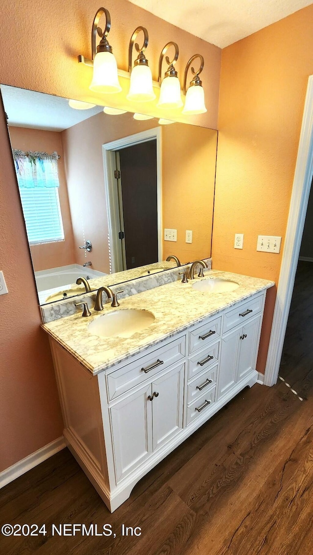 bathroom featuring vanity and hardwood / wood-style flooring