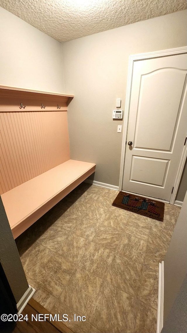 mudroom with a textured ceiling