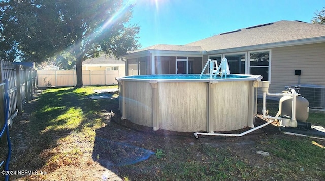 view of yard featuring a fenced in pool and cooling unit