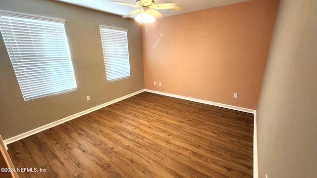 spare room with hardwood / wood-style floors, ceiling fan, and a textured ceiling