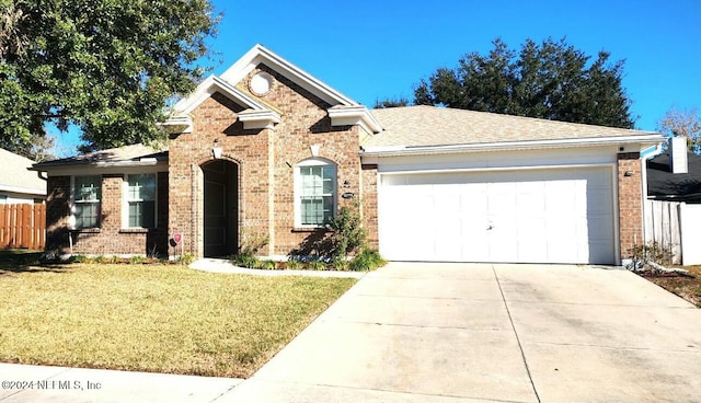 view of front of home with a garage and a front lawn