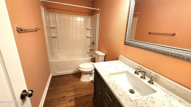 full bathroom with hardwood / wood-style flooring, vanity, toilet, and washtub / shower combination