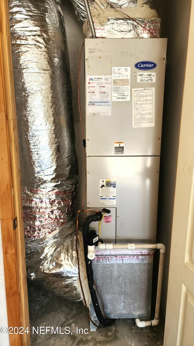 utility room featuring heating unit