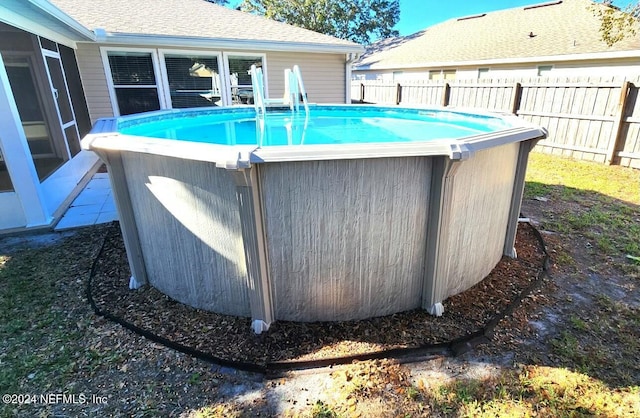 view of pool featuring a sunroom