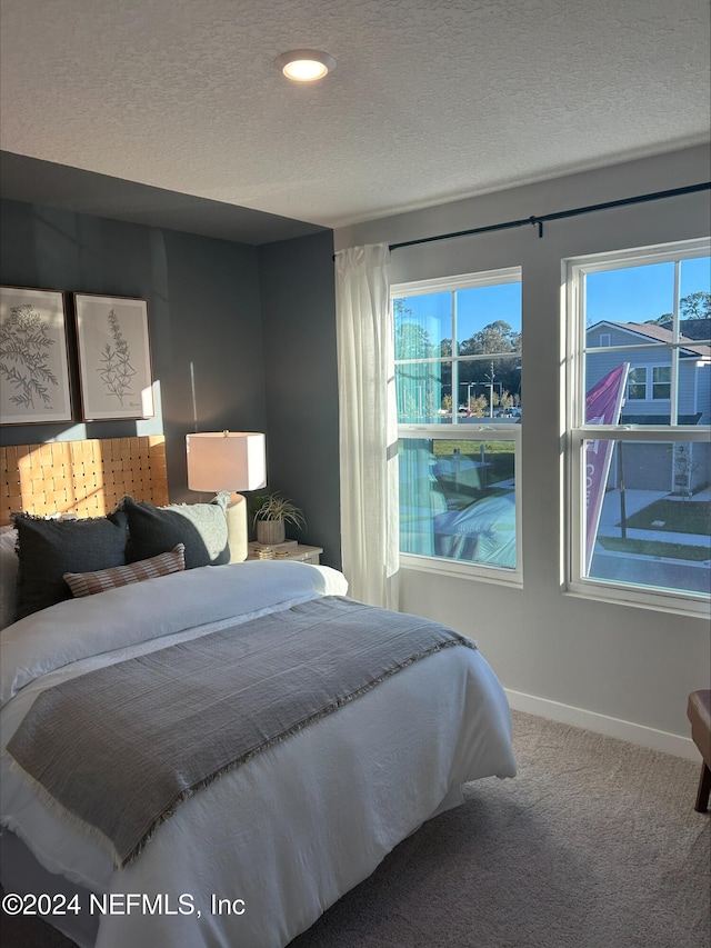 carpeted bedroom with a textured ceiling