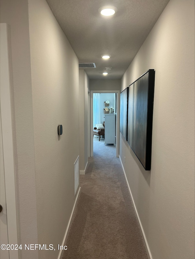 corridor with carpet flooring