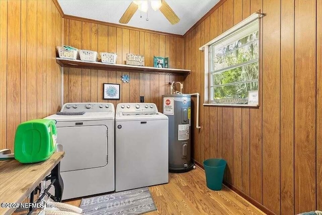 clothes washing area with ceiling fan, separate washer and dryer, electric water heater, light wood-type flooring, and ornamental molding