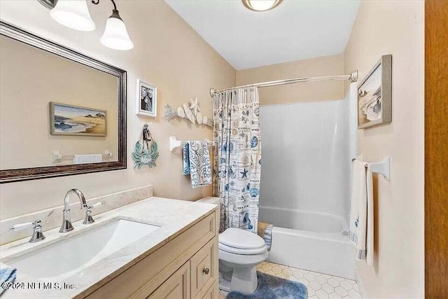 full bathroom featuring tile patterned flooring, shower / bath combination with curtain, toilet, and vanity