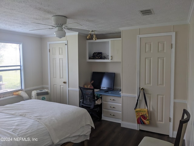 bedroom featuring a textured ceiling, ceiling fan, dark hardwood / wood-style floors, and crown molding