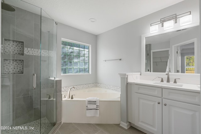 bathroom featuring tile patterned floors, vanity, and plus walk in shower