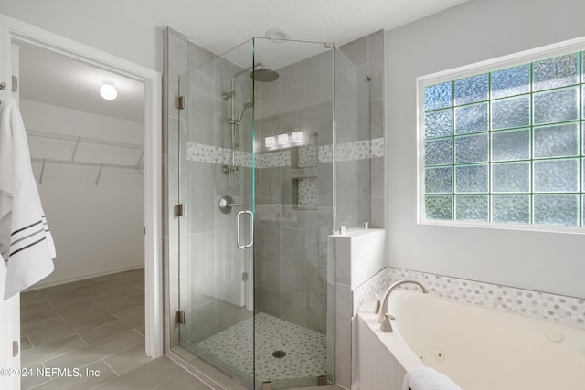 bathroom featuring shower with separate bathtub