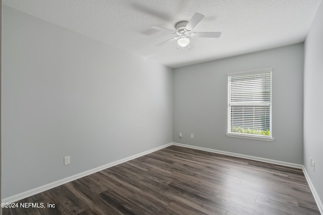 empty room featuring a textured ceiling, dark hardwood / wood-style flooring, and ceiling fan