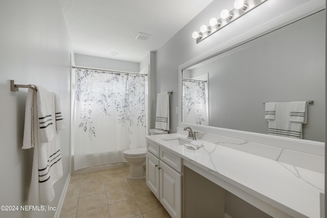 full bathroom featuring vanity, tile patterned flooring, toilet, a textured ceiling, and shower / tub combo with curtain