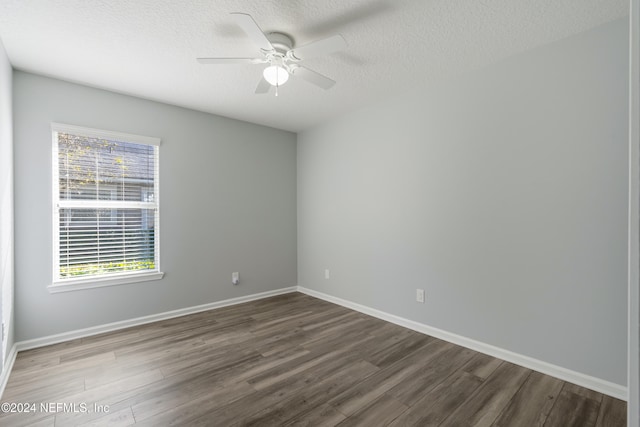 spare room with ceiling fan, dark hardwood / wood-style flooring, and a textured ceiling