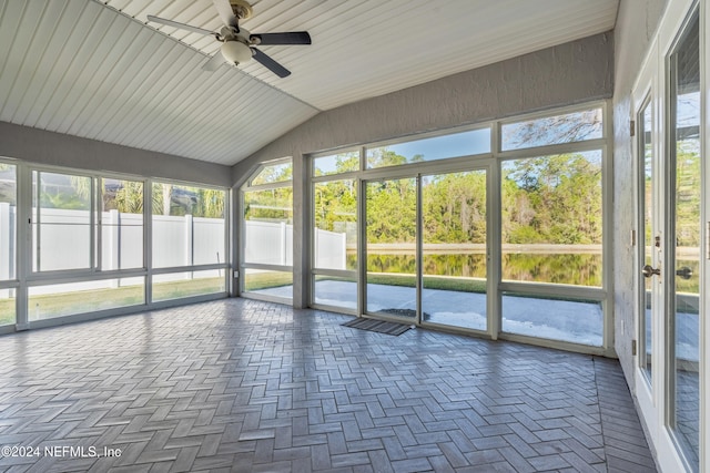 unfurnished sunroom with a wealth of natural light, ceiling fan, and lofted ceiling